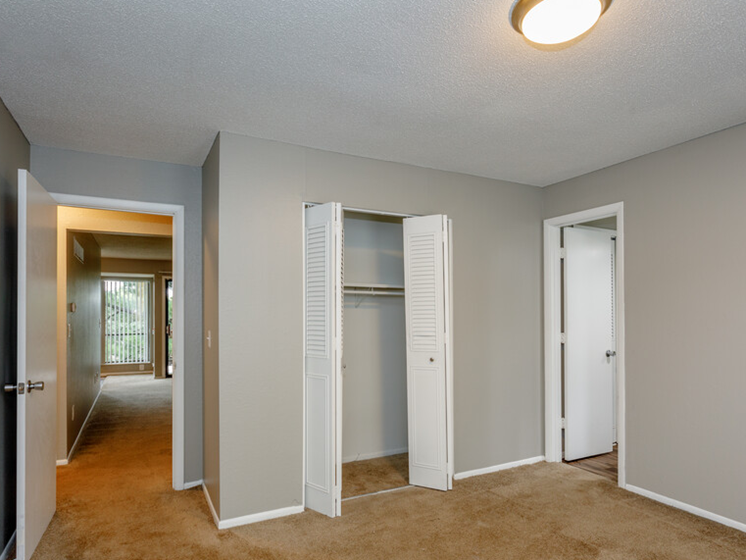 large carpeted room with closet